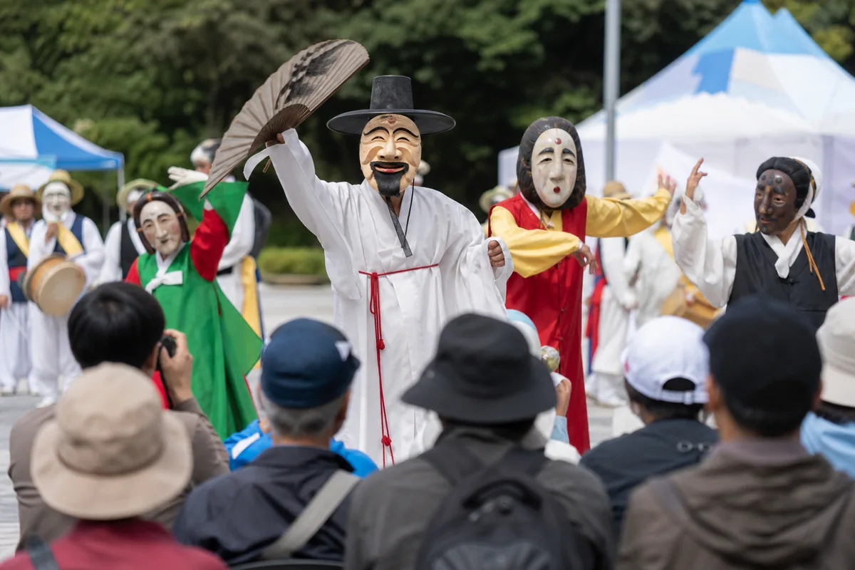 andong maskdance festival outdoor parade performance with traditional masks and visitors