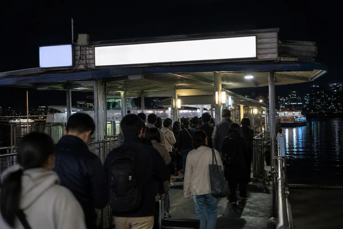 foreign traveler walking from the subway toward a Hangang Bus pier inside a Seoul riverside park